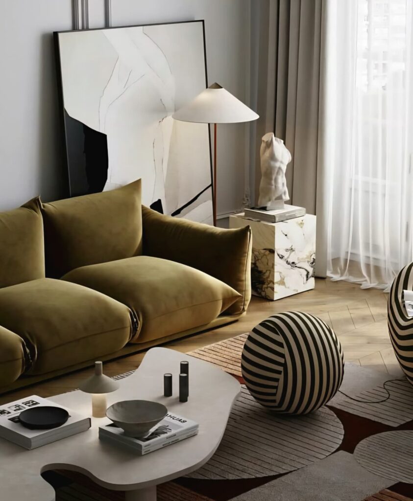 Contemporary living room with an olive green sofa, sculptural art, and abstract decor elements.