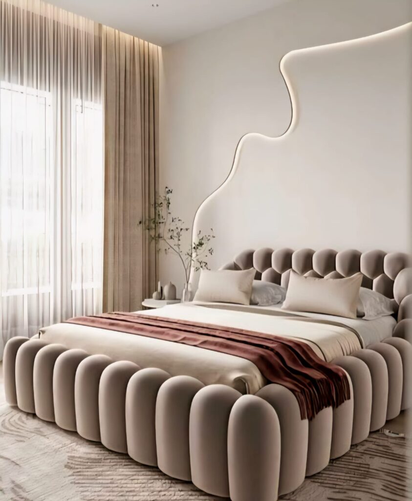 Rounded, tufted bed frame with sculptural headboard highlights 2025 headboard design trends in a soft neutral bedroom.