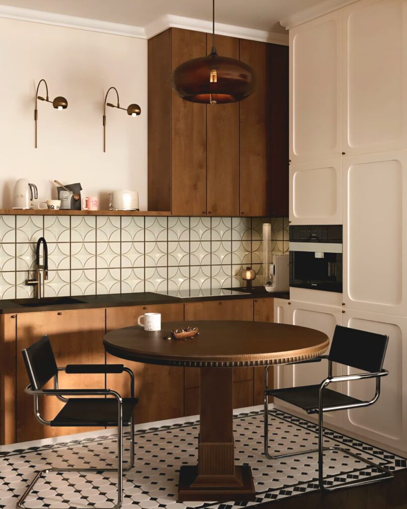 Minimal small kitchen with dark wooden cabinets, geometric ceramic backsplash, and a black round dining table creating a warm, natural atmosphere.